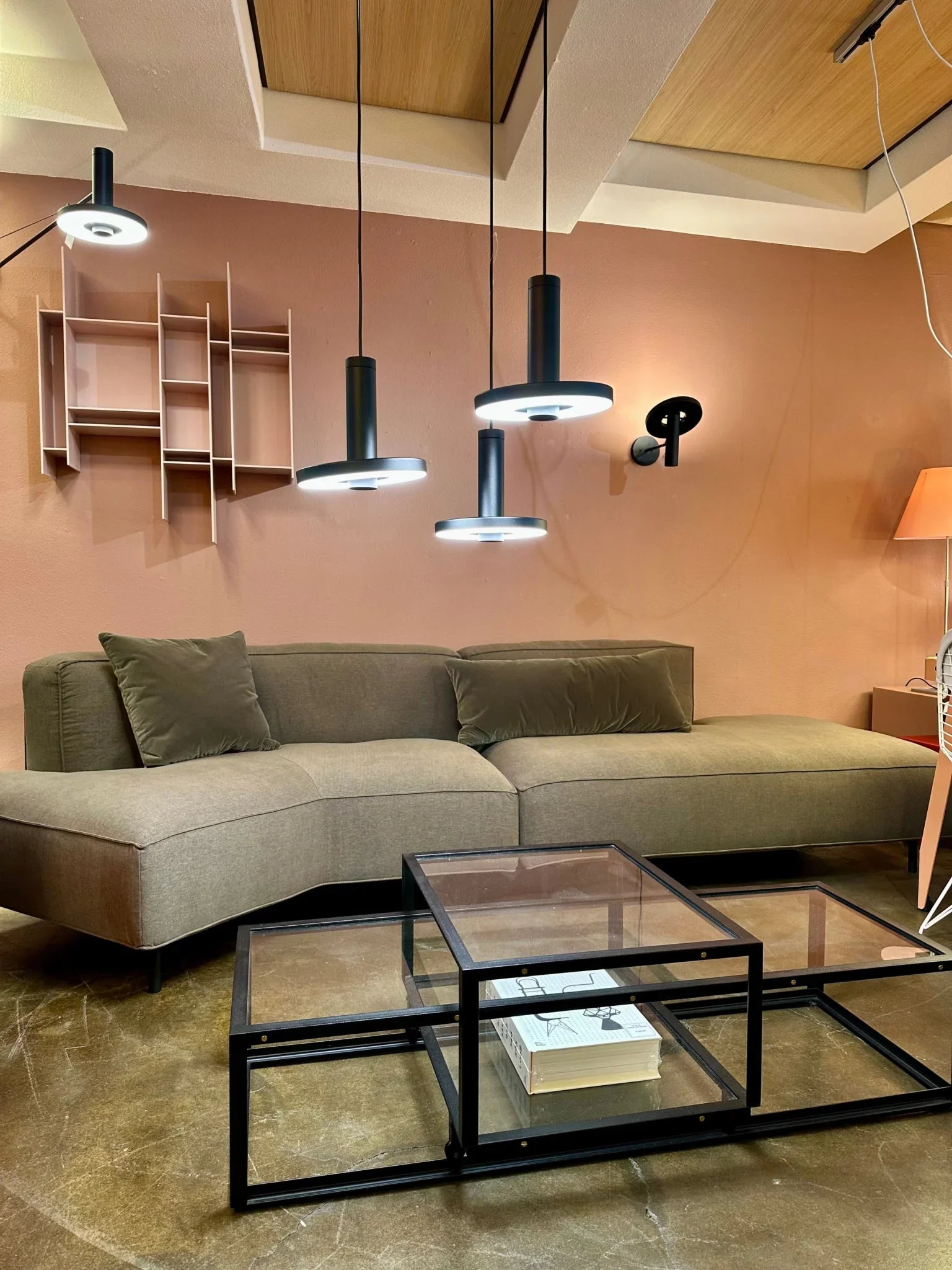 Salontafel met glazen blad en metalen steunen.