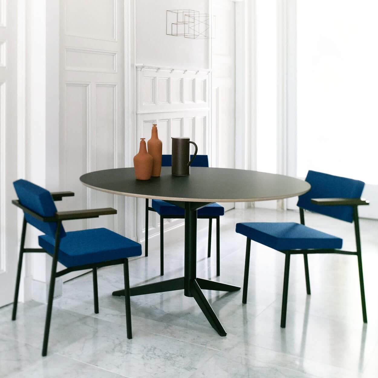 Ronde tafel met blauwe stoelen.